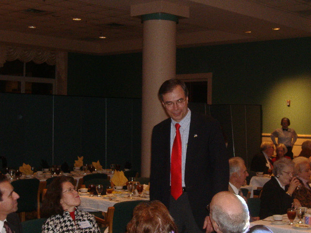 State Senator Andy Harris (standing) talks to a table full of prospective voters.